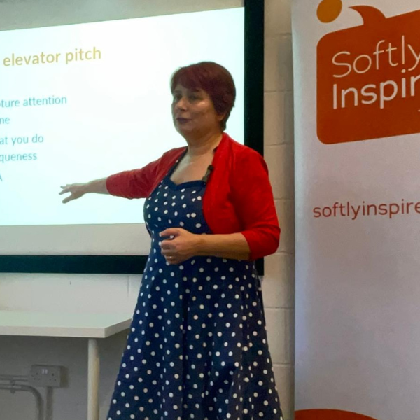 5 Photo of Julie Kenny presenting and pointing at a presentation